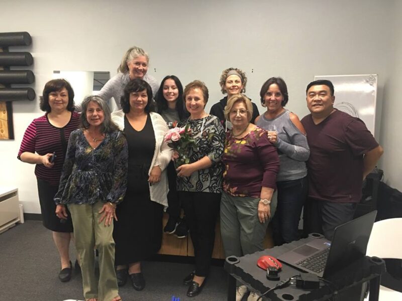 Healthcare practitioners and instructors at a RITMSCENAR training session for neuro-adaptive electrostimulation.